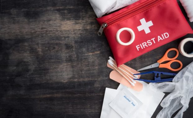 First aid kit on wooden table