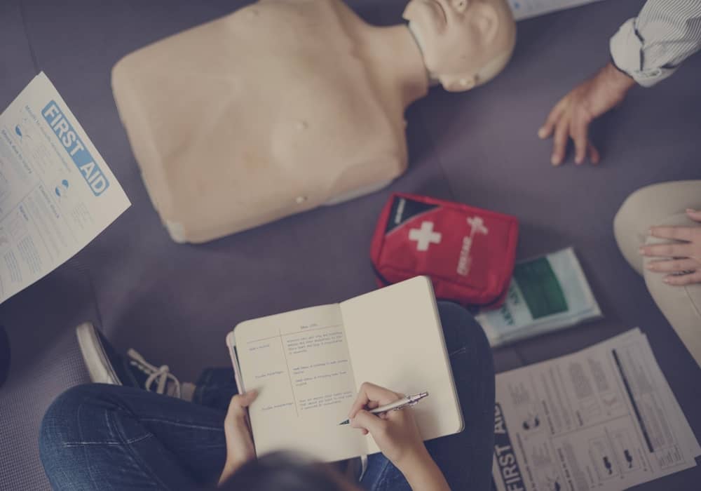 First aid level 1 training for employees with first aid notes and cpr dummy