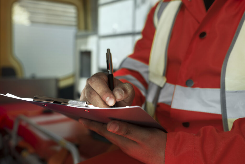 Having a safety management plan is important. This image shows a person going through a safety management plan on a red clipboard
