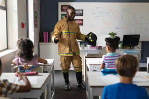 A firefighter teaching evacuation training for schools